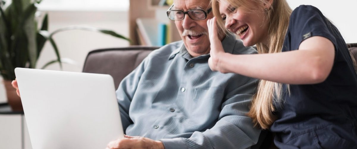 smiley-old-man-nurse-having-video-call-laptop (1)